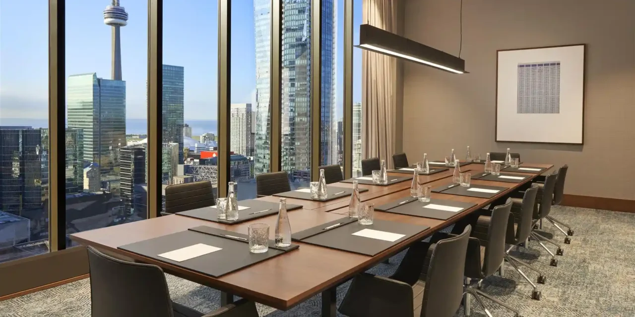 Boardroom overlooking Toronto’s skyline, illustrating Praevion services for business leaders