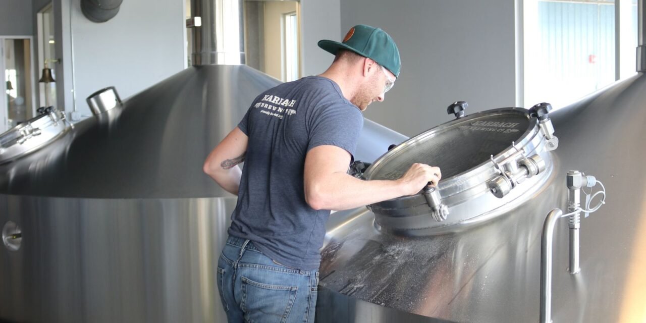 What Is Process Improvement and Where Should You Start? 1 Brewery worker inspecting production equipment during process improvement