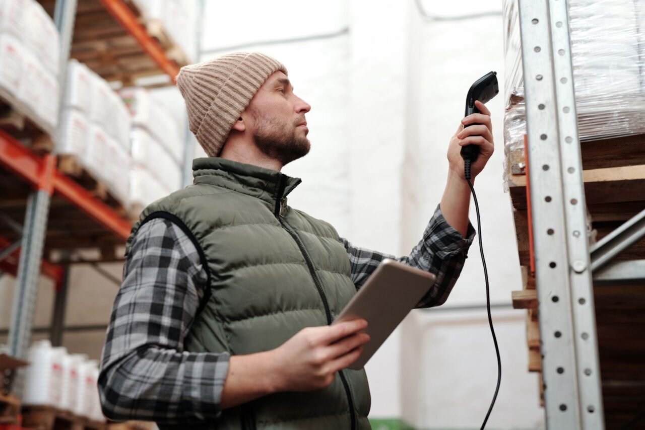 What Is Operational Excellence and How Is It Achieved? 2 Warehouse employee scanning inventory to control process flow