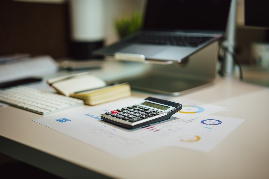 How Do You Measure the Financial Impact of Process Improvement? 4 Calculator and laptop used to calculate process improvement ROI