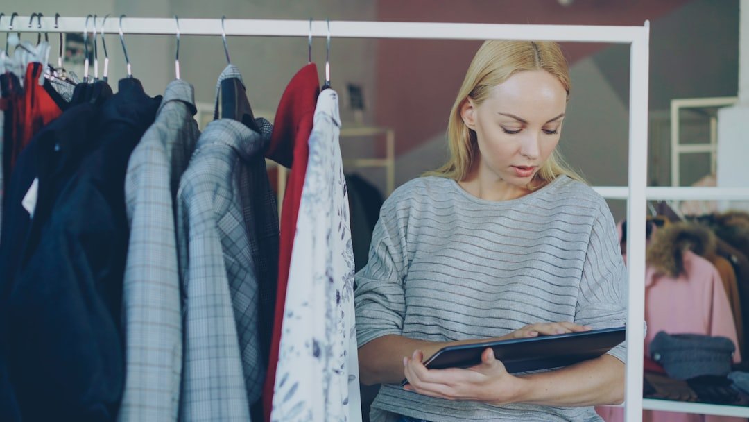 What Is the Difference Between a KPI and a Metric? 2 retail manager checking inventory metrics in a clothing store